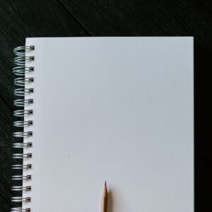 white spiral notebook on black wooden table